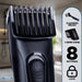Black Status cordless hair clippers with a multi-comb guide attachment, shown alongside an informational graphic detailing features like a cleaning brush, 1-15mm comb, 8 settings, and lock.