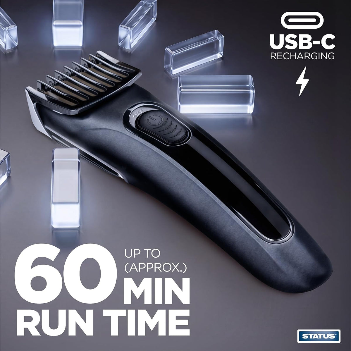 A black Status USB-C rechargeable cordless hair clipper with guide comb, shown on a dark gray reflective background with glowing crystal-like blocks and promotional text reading '60 MIN RUN TIME' and 'USB-C RECHARGING'.