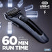 A black Status USB-C rechargeable cordless hair clipper with guide comb, shown on a dark gray reflective background with glowing crystal-like blocks and promotional text reading '60 MIN RUN TIME' and 'USB-C RECHARGING'.