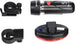 A bicycle light kit shown on a white background, including a black cylindrical light with a red button and white text, a black ring clamp, a black clip-on mount, and a black oval reflector with a red rear panel and blue button.